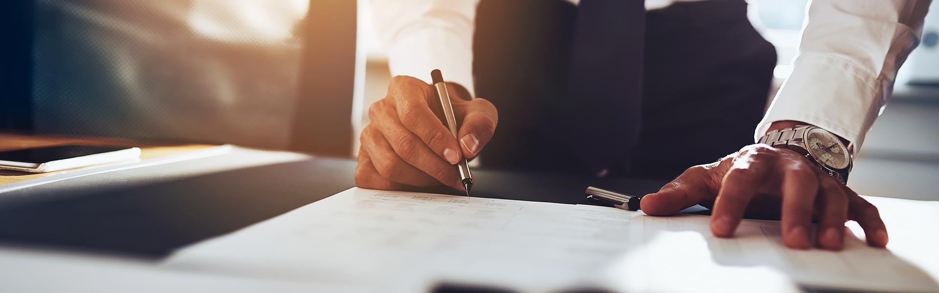 A man signing a loan application
